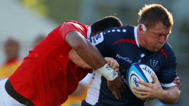 Former All Black, Greg Somerville, makes a charge for the Rebels.