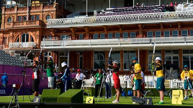 Australian archers Elisa Barnard and Taylor Worth practise in the foreground of a historic stand at Lord's yesterday.