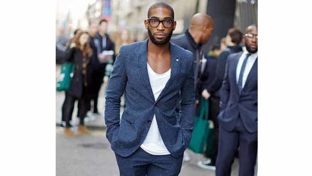 Rapper Tinie Tempah adds casual cool by wearing a basic t-shirt under a suit jacket.