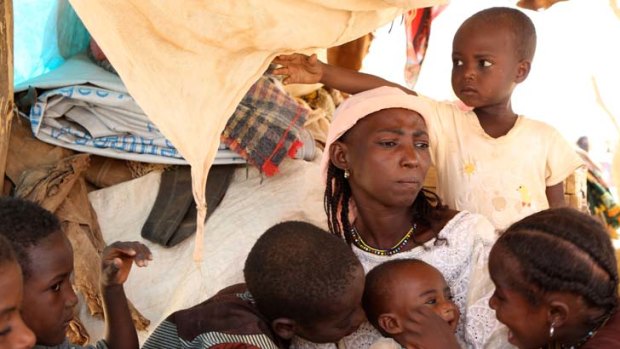 Displaced hope &#8230; Malian refugee Saouda Baye mourns the death of her two-year-old son, Moussa, while another is being treated for malnutrition at a camp in Mangaize, in neighbouring Niger.
