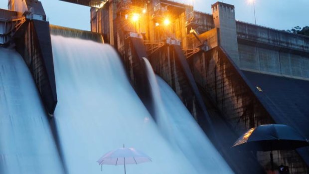 Going with the flow … Warragamba Dam spills over for the first time in 14 years, providing quite a spectacle for a small crowd of police, water catchment staff and sightseers.