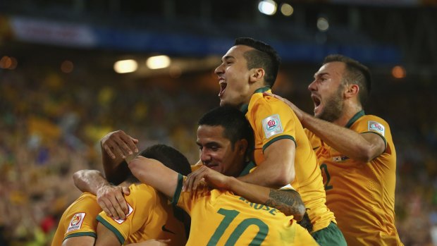 Tim Cahill,  Jason Davidson and Ivan Franjic of Australia celebrate after Massimo Luongo of Australia scored.