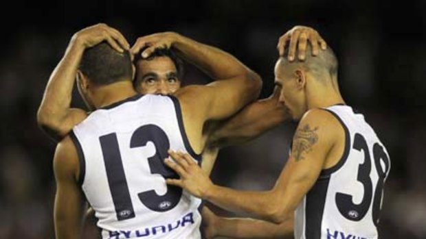 Carlton's Chris Yarran (13) and Jeff Garlett (38) celebrate with Eddie Betts after one of Betts' five  goals last night against St Kilda.