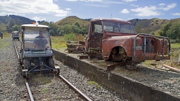 Golf carts heading through an old siding on the railway line into the Forgotten World.