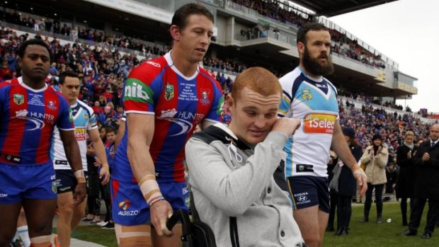 Mark of respect: Kurt Gidley helps Alex McKinnon onto the field for the Rise For Alex round.
