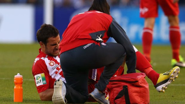 Josip Tadic of the Heart is checked for an injury during the round 19 match against Melbourne Victory.