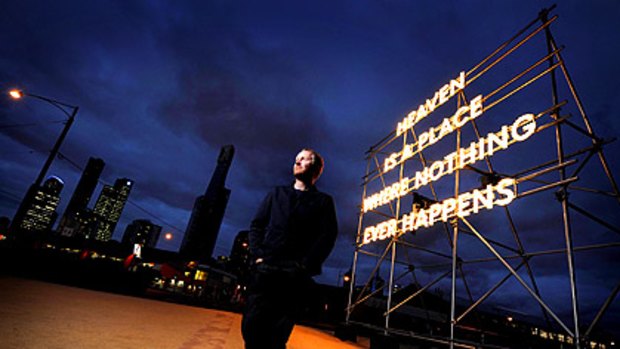 Artist Nathan Coley stands at Southbank in front of his work ''Heaven Is A Place Where Nothing Ever Happens'', part of the 2010 Melbourne International Arts Festival.