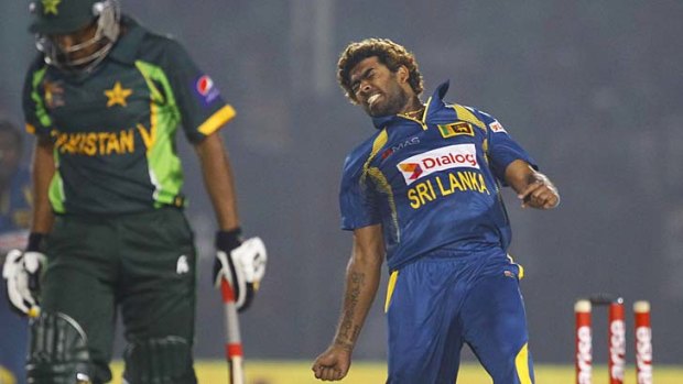 Sri Lanka's Lasith Malinga, right, celebrates taking the wicket of Pakistan's Bilawal Bhatti.