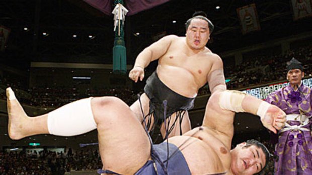 Asashoryu throws Kotomitsuki to the ground at the Autumn Grand Sumo tournament in Tokyo last month.