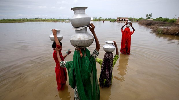 Girls wade through floodwaters in Pakistan's Sindh province.
