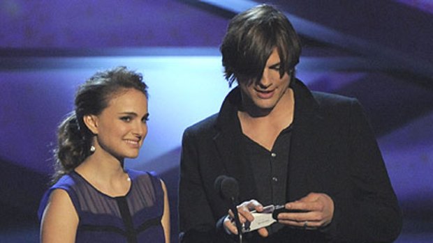 A pregnant Natalie Portman and co-presenter Ashton Kutcher announce nominees for the favorite movie award at the 2011 People's Choice Awards in Los Angeles
