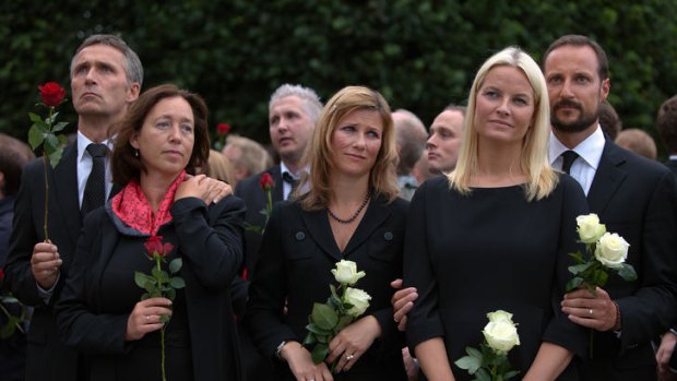 Prime Minister of Norway Jens Stoltenberg (left), holds his wife Ingrid Schulerud as Princess Martha Louise of Norway (centre), Crown Princess Mette-Marit of Norway and Crown Prince Haakon of Norway look on at today's memorial vigil.