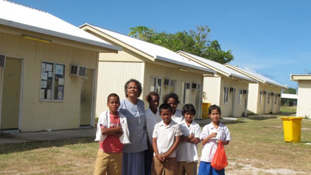 Principal Jocelyn Adam with students at Aiwo Primary School, formerly an Australian-built detention centre.