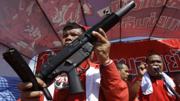 An automatic weapon is displayed during a Bangkok rally of thousands of protesters supporting exiled Prime Minister Thaksin Shinawatra.