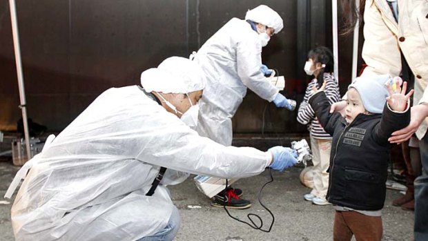 Officials check for radiation on people who lived near a nuclear plant.