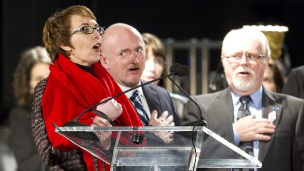 ''I pledge allegiance'' &#8230; Gabrielle Giffords, accompanied by her husband, Mark Kelly, leads a vigil on the anniversary of last January's supermarket shootings in Tucson.
