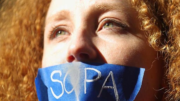 Protester Nadine Wolf demonstrates against the proposed Stop Online Piracy Act (SOPA) and Protect IP Act (PIPA) outside the offices of US Senators Charles Schumer and Kirsten Gillibrand in New York City.