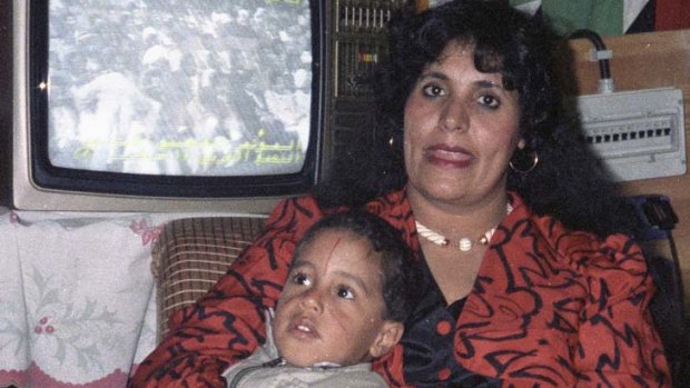 Safia Gaddafi, wife of Muammar Gaddafi, is pictured with one of her children in this 1986 file photo.