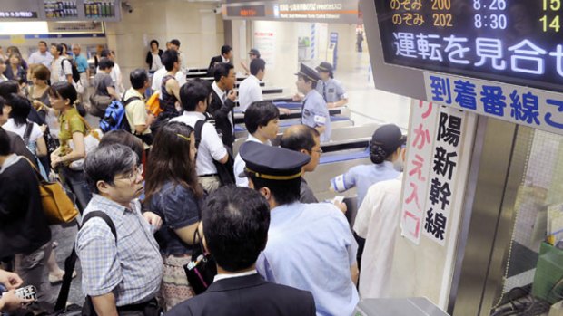 Commuters are left stranded at Tokyo Station after a magnitude 6.6 earthquake forces train services to be suspended.