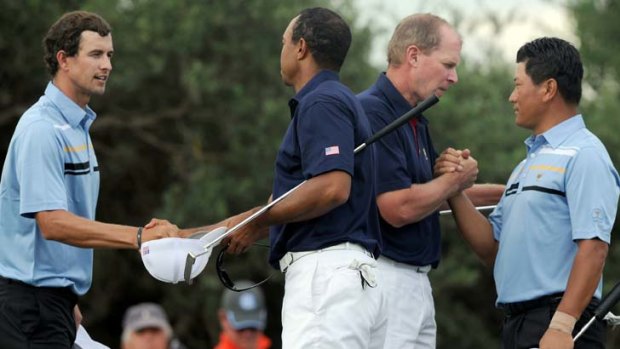 In the bag ... Tiger Woods and Steve Stricker concede to K.J Choi and Adam Scott.