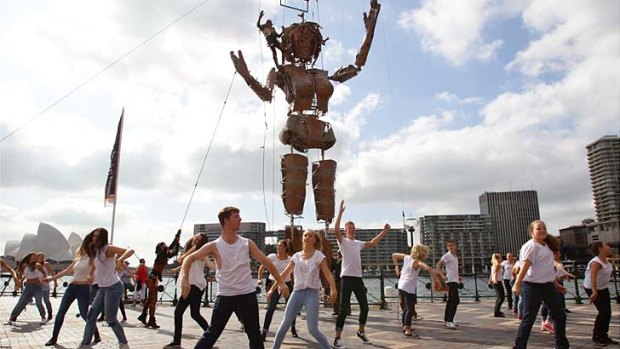 High time: Darcy, the three-storey steel puppet, and dancers at a preview in Circular Quay before the Royal Easter Show.