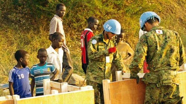 Officers from the UNMISS Japanese contingent building latrines for civilians seeking refuge.