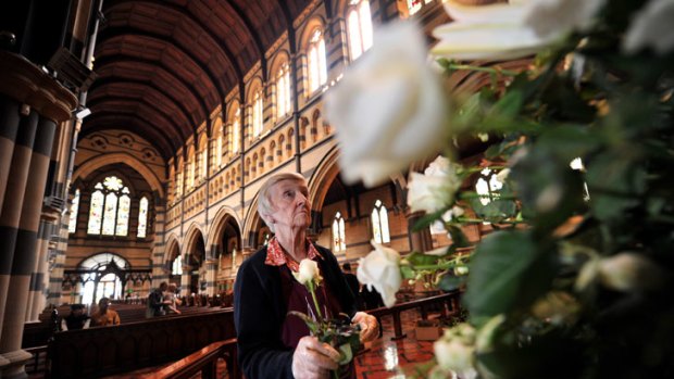Jeanette Skipper arranges flowers for the Jim Stynes funeral at St Paul's Cathedral today.