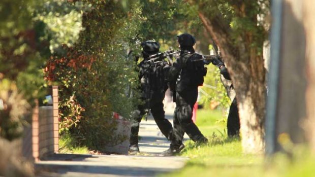 Police enter the ground the house in Glenroy.
