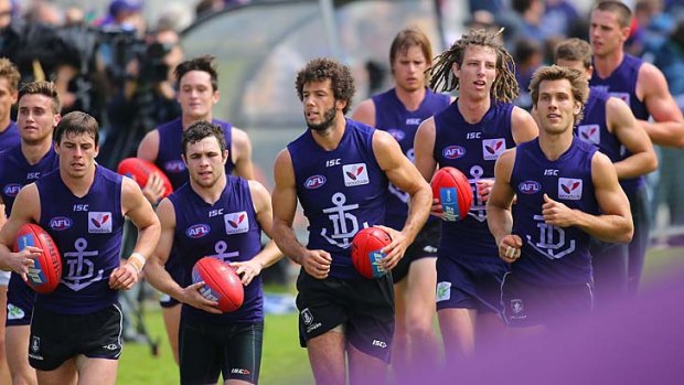 Fremantle players do a lap of the ground to acknowledge supporters after a training session at Fremantle Oval on Tuesday.