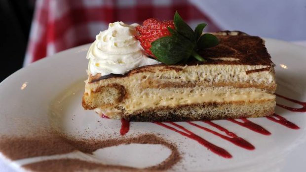 Tiramisu, homemade slice consisting of lady sponge finger biscuits dipped in coffee and liquers with fresh marscapone cream.