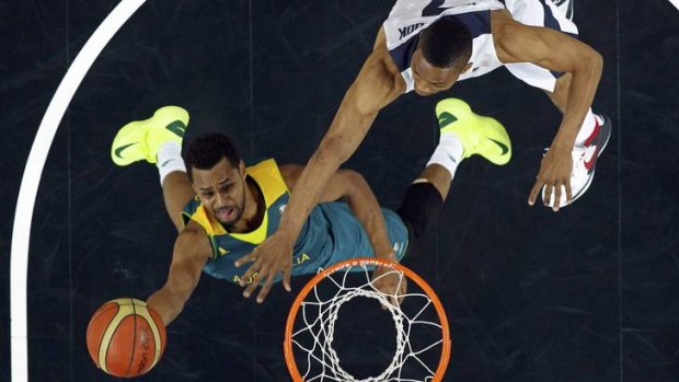 Australia's Patrick Mills (left) goes in for a lay-up past Russell Westbrook of the United States.