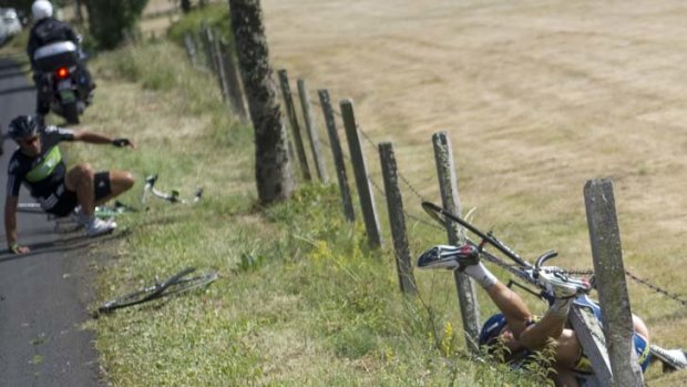 Chaos ... a French TV car hits Juan Antonio Flecha, who crashes into Johnny Hoogerland - sending the Dutchman flying into a barbed wire fence at the side of the road.