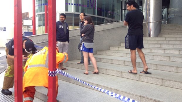 'It was pretty full on': Evacuated residents wait outside the apartment block on Tuesday morning.