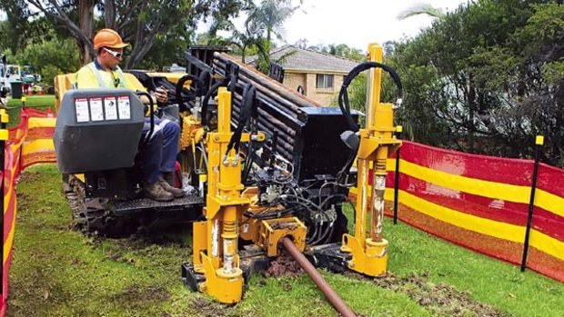 The front line... a cable-laying machine at work in Tarrant Avenue in Kiama Downs.