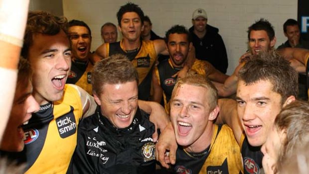 Richmond coach Damien Hardwick (second from left) celebrates the Tigers' first  win of the season, and his first as a senior AFL coach, with his players at AAMI Stadium yesterday.