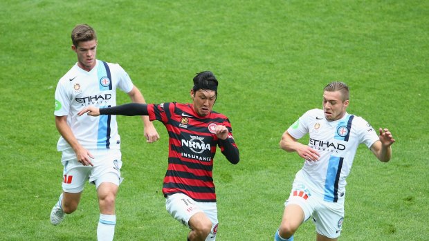 Yojiro Takahagi of the Western Sydney Wanderers comes under pressure from Connor Chapman and Jacob Melling of Melbourne City.