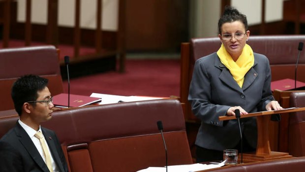 Jacqui Lambie in the Senate, flanked by fellow PUP senator Dio Wang.