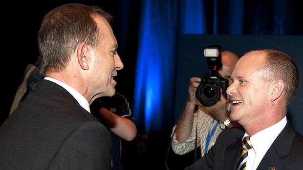 Federal Opposition leader Tony Abbott shakes hands with Campbell Newman at the LNP launch in Brisbane, March 4, 2012.