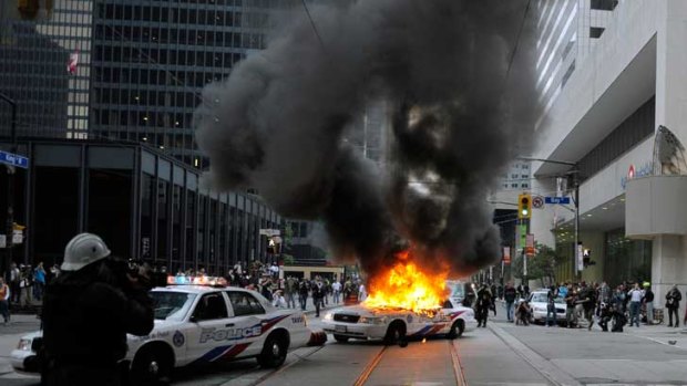 A police car burns on the streets of Toronto during G20 protests in June 2010.