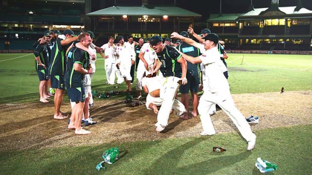 Cheers mate: Chris Rogers pours beer on David Warner while the players celebrate the 5-0 Ashes whitewash.
