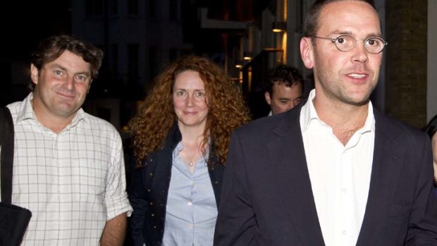 James Murdoch, right,  Rebekah Brooks  and her husband Charlie Brooks, left, leave a hotel in central London on Sunday.