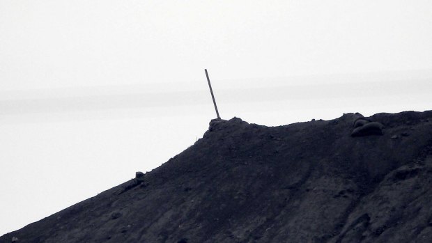 Removed: A black flag of the Islamic State has been taken down after it was raised on top of a hill two weeks ago in Kobane, Syria.