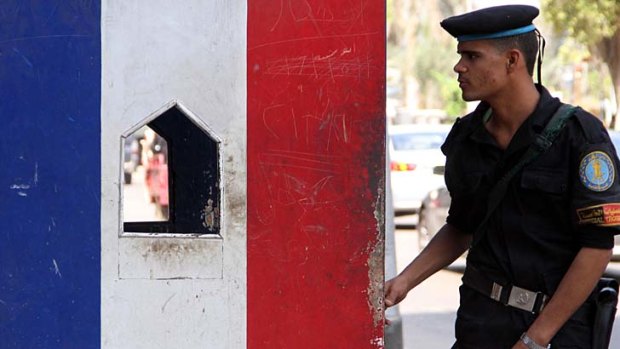 An Egyptian special force officer stands guard outside the French embassy in Cairo. France will close 20 diplomatic posts in Muslim countries on Friday.