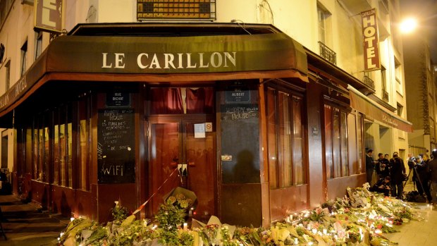 Flowers and candles are placed outside Le Carillon bar.