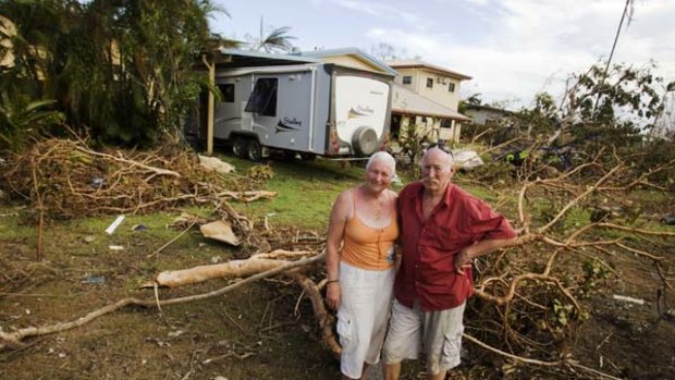 Staying out and remaining cheerful ... Eddie and Claire Hollyoak in their cyclone-ravaged backyard.