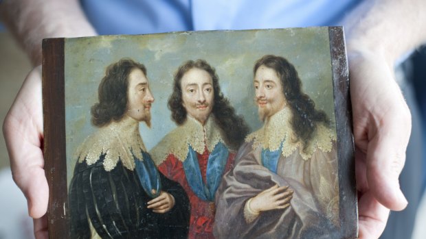 Robert Edsel holds a portrait of England's King Charles I in Three Positions, a piece taken from Germany by Americans in World War II, in Dallas. Paintings that an American soldier won in a poker game are among the treasures plundered during World War II that are returning to Germany. 