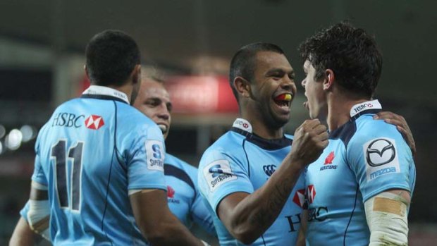 Kurtley Beale and Tom Carter celebrate one of Carter's three tries in the Waratahs' victory over the Highlanders.