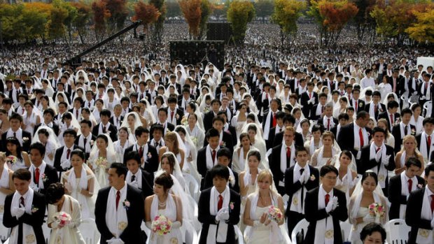 Couples from around the world join in a mass wedding ceremony in 2009 arranged by the Reverend Sun Myung Moon's Unification Church at Sun Moon University in Asan, South Korea.