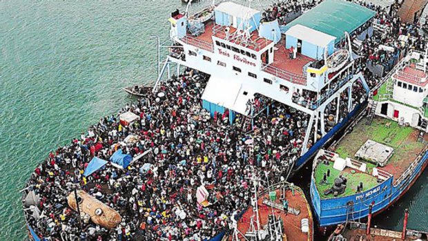 Haitians crowd a ship after earthquake devastation left many homeless, injured and hungry.