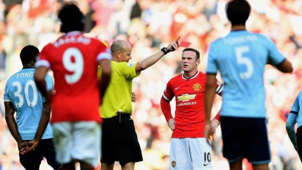 Marched:  Manchester United skipper Wayne Rooney is sent packing by referee Lee Mason.